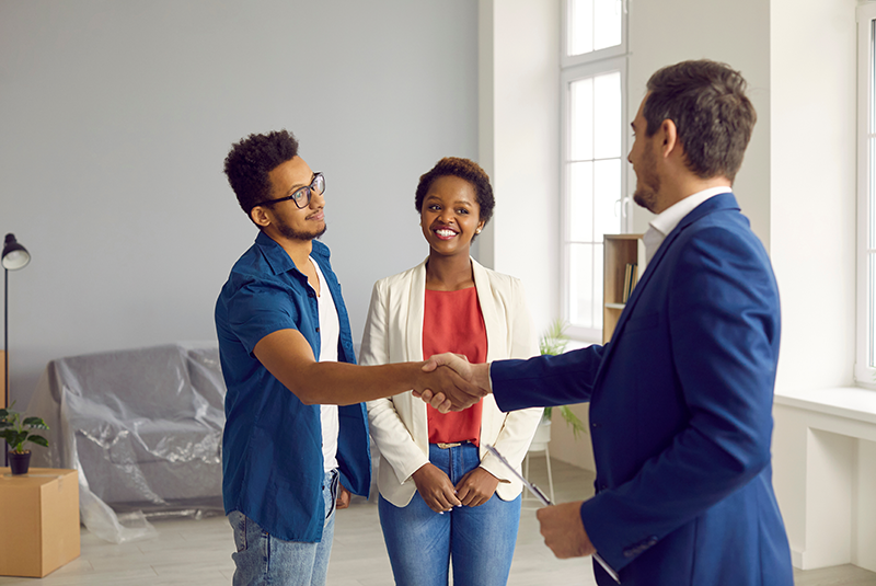 A couple shaking hands with an advisor.