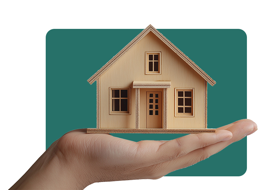 A hand holding a small wooden house.
